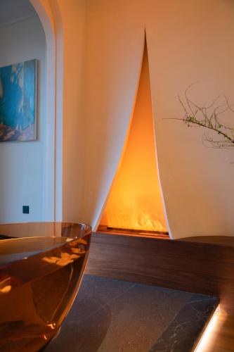 a fireplace in a room with a glass table at Zhangjiajie Yujie Hotel in Zhangjiajie
