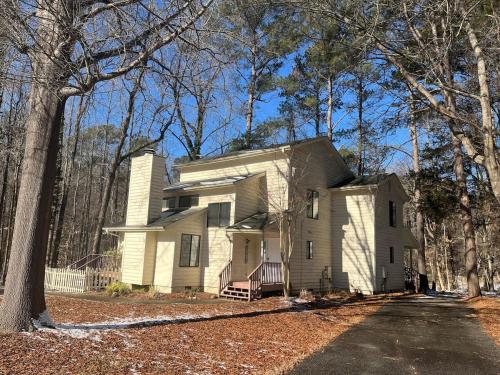 a white house in the middle of the woods at Quiet 2 bedroom house close to UNC Duke RTP in Chapel Hill