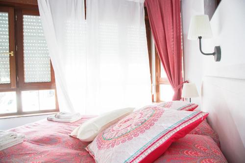 a bedroom with a bed in front of a window at Alojamiento Miramar in Santoña