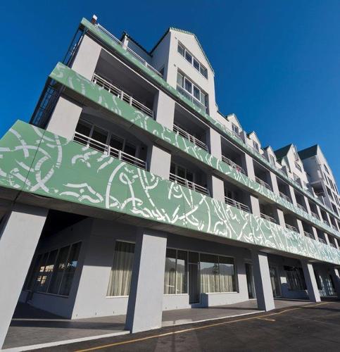 a building with graffiti on the side of it at Krystal Beach Hotel in Gordonʼs Bay