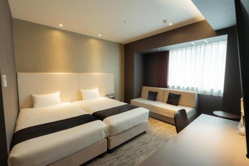 Katil atau katil-katil dalam bilik di Hotel Aqua Citta Naha