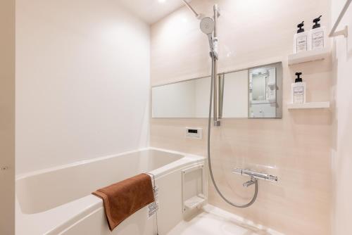 a bathroom with a shower and a bath tub at 和-羽田 in Tokyo