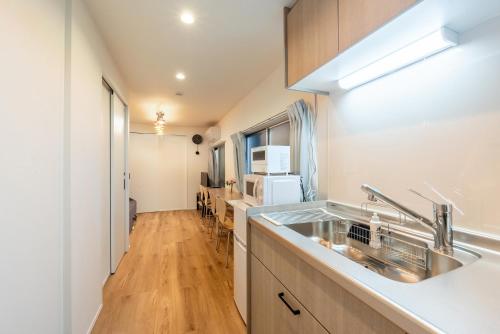 a kitchen with a sink and a counter top at 和-羽田 in Tokyo
