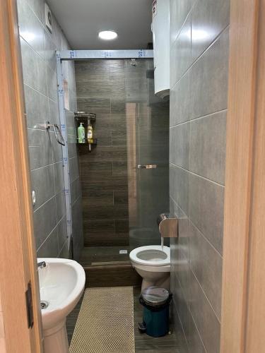 a small bathroom with a toilet and a sink at Nanik Hostel in Khorog