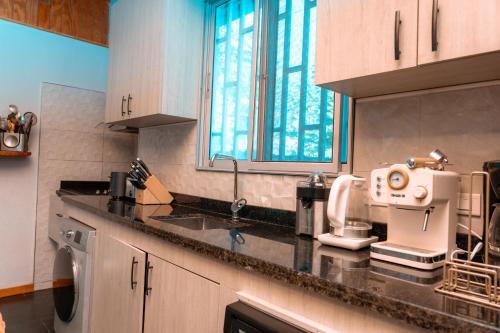 a kitchen with a counter top with a sink at Star Apple Inn in San Andrés