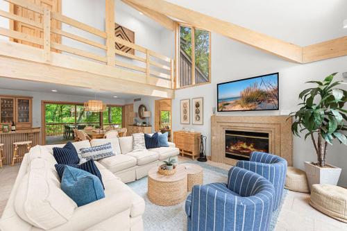 a living room with couches and a fireplace at Treehouse Oasis in New Buffalo