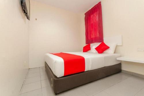 a bedroom with a bed with a red window at Skudai Hotel Johor Bahru in Skudai