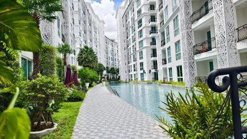 a canal between two apartment buildings with buildings at City Garden Olympus by dw in Pattaya South