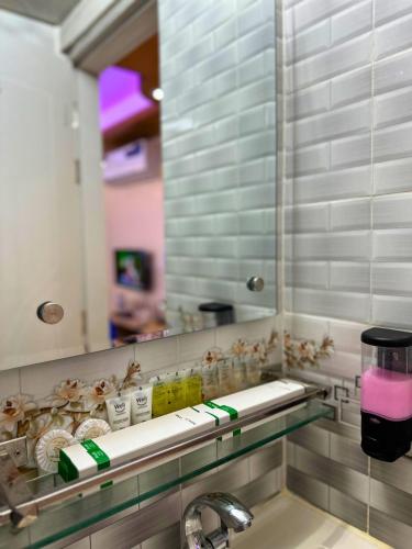 a bathroom with a sink and a mirror at The Ambassador Hotel Dhanmondi in Dhaka