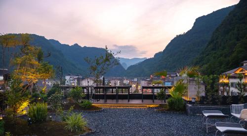 a view of a town with mountains in the background at Zhangjiajie Yujie Hotel in Zhangjiajie