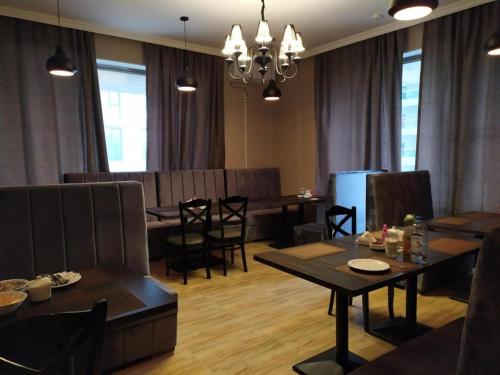 a living room with a table and a dining room at The Clocktower Hotel in Baku