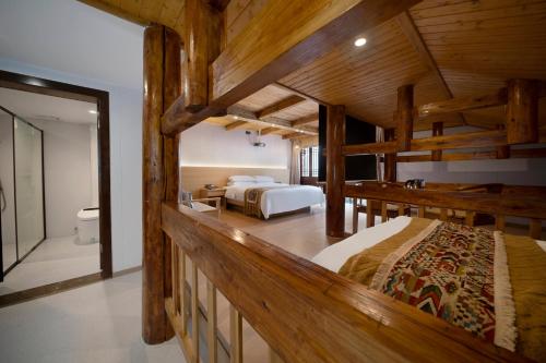 a bedroom with two bunk beds and a bathroom at Shanyeji Garden Resort Panorama Hotel in Xinping