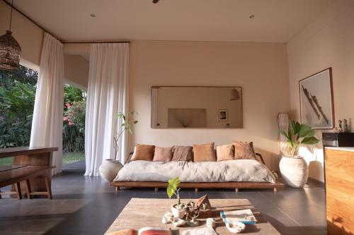 a bedroom with a bed and a large mirror at Tropical Escape 2min Walk to Beach and Private Pool in Cemagi