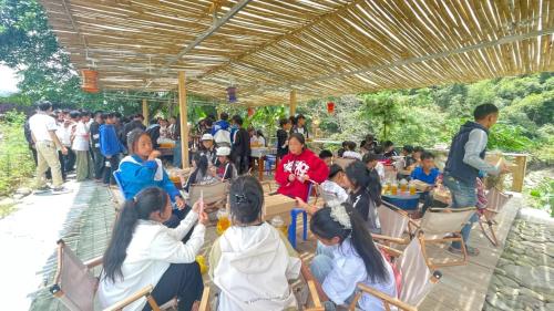 a group of people sitting in chairs under a tent at Sapa Retreat Homestay & Restaurant in Lao Cai