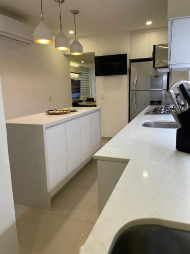 a kitchen with white cabinets and a refrigerator at Excellent apartment in Chapalita, everything new in Guadalajara