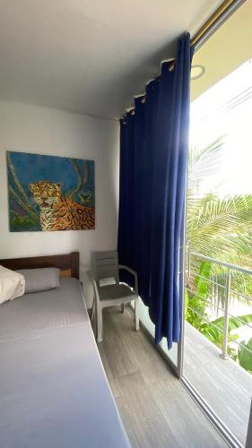 a bedroom with a bed and a large window at Amazonas magic in Leticia