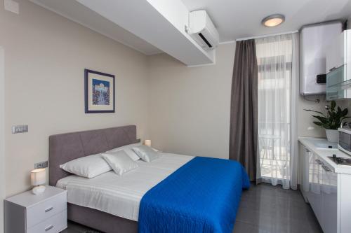 Katil atau katil-katil dalam bilik di Apartments ZoomZoom