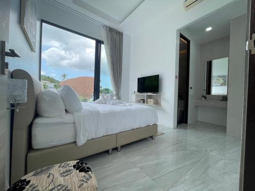 a bedroom with a large bed and a large window at The Blue Lion Villa koh Samui - Sea view in Chaweng Noi Beach