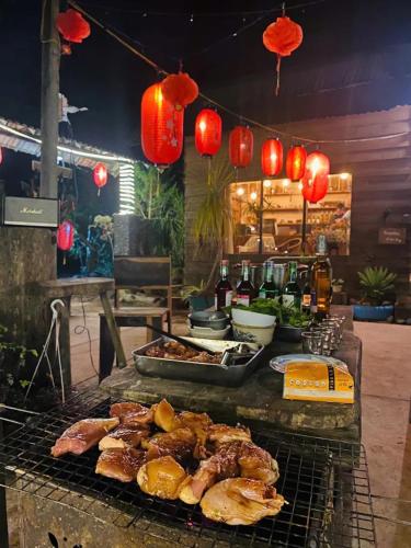a grill with meat and other food on it at The Sound Of Silence Homestay Đà Lạt in Da Lat