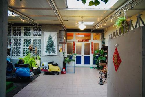 a lobby with motorcycles parked in a building at Liu Xu Homestay in Tainan