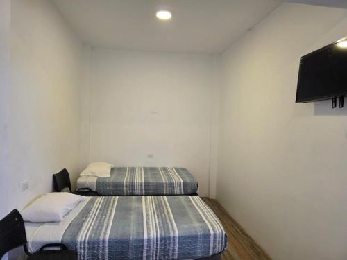 Postel nebo postele na pokoji v ubytování Hostal nancy