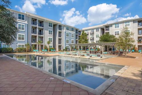 a courtyard with a pool in front of a building at Frisco Getaway in Frisco