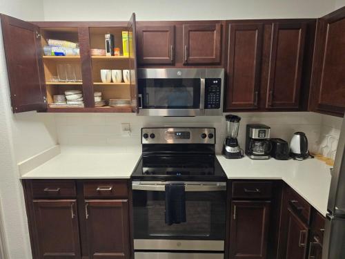 a kitchen with a stove and a microwave at Frisco Getaway in Frisco