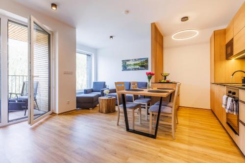 a kitchen and living room with a table and chairs at Apartmán Jako doma in Dolní Morava