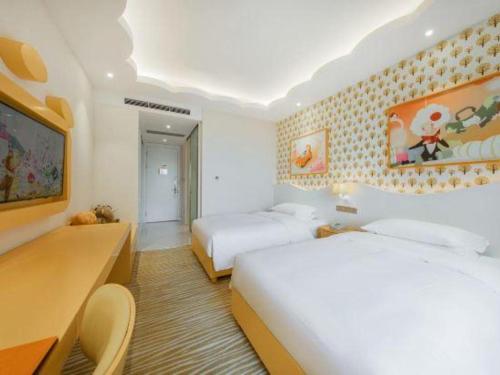 a hotel room with two beds and a tv at Deefly Yinrun Town Hotel in Deqing
