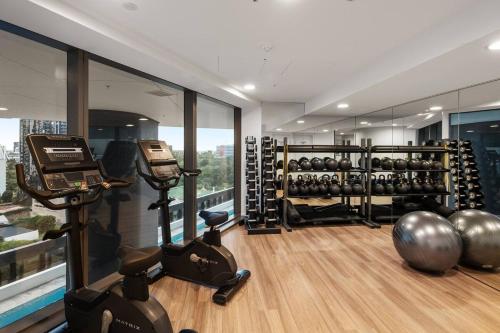 a gym with dumbbells and weights in a room at Queen's Wharf Brisbane The Star Luxurious 1 Bed in Brisbane