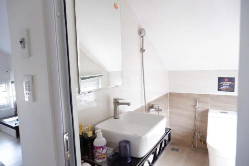 a bathroom with a sink and a toilet at An Nam Paradise Dalat in Da Lat
