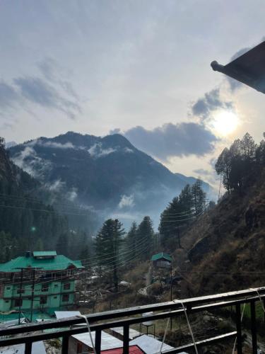 a view of a mountain from a window of a building at Trippy Homestay in Kasol