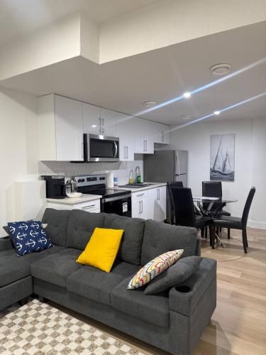 a living room with a couch and a kitchen at Amazing 2-bedroom house with WiFi in Edmonton in Edmonton