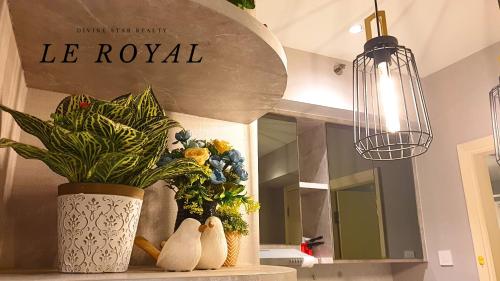 a vase with a plant on a shelf in a kitchen at Le Tresor Benson Apartment at Supermal Pakuwon in Surabaya