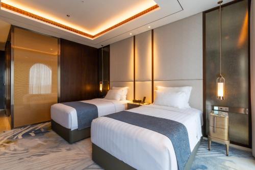 a hotel room with two beds in a room at Arjuna Resort & Spa in Sihanoukville