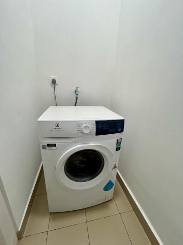 a washing machine in a corner of a room at KL Central 31st floor KLCC view in Kuala Lumpur