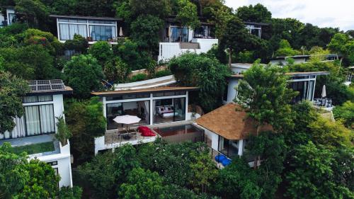 an aerial view of a building with trees at Pahili Pool Villas Koh Tao - SHA Plus in Koh Tao