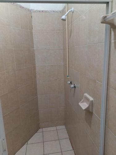 a bathroom with a shower with a toilet at Affordable and Comfortable, Location, Delfines in Manzanillo