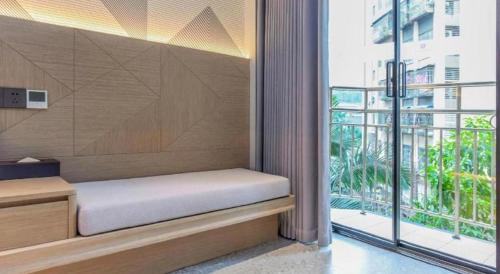 a bed in a room with a large window at Borrman Hotel Chongqing Bishan Central Street in Chongqing