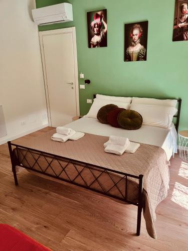 a bed with two towels on it in a bedroom at Sea Breeze Suites in Livorno