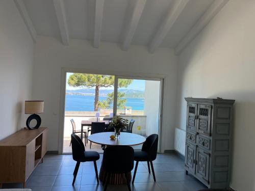 une salle à manger avec une table et des chaises et une fenêtre dans l'établissement La villa Timeo, à Pietrosella