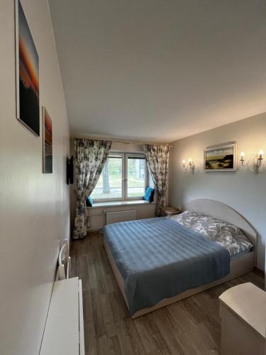 Ένα ή περισσότερα κρεβάτια σε δωμάτιο στο Girulių apartamentai prie jūros