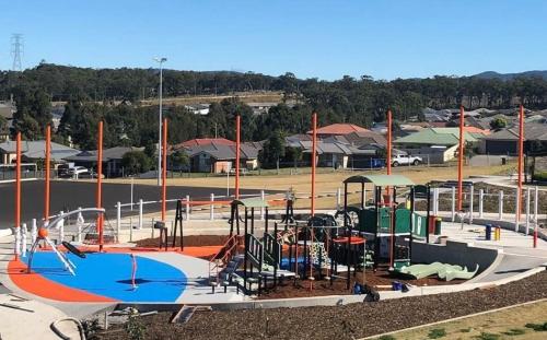 a park with a water park with a playground at The Retreat Modern Cosy Stylish in Holmesville