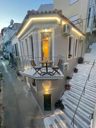 a balcony with a table and chairs on a house at Yataki Cozy House in Plomarion