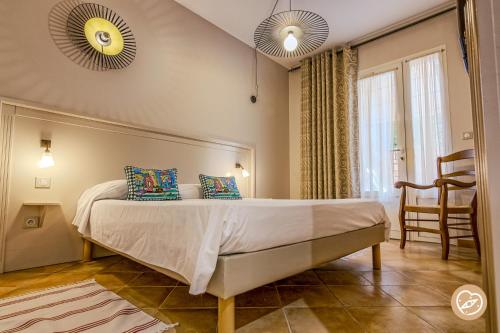 a bedroom with a large bed with two mirrors at Hotel Les Restanques De Moustiers in Moustiers-Sainte-Marie