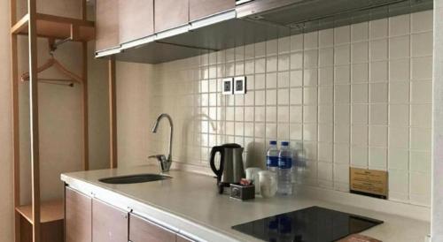 a kitchen with a sink and a counter top at Kingtown Hotel Hongqiao Shanghai in Shanghai