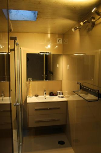 a bathroom with a sink and a shower at Casa do Ramiscal - Eido do Pomar in Sistelo
