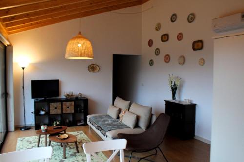 a living room with a couch and a table at Casa do Ramiscal - Eido do Pomar in Sistelo