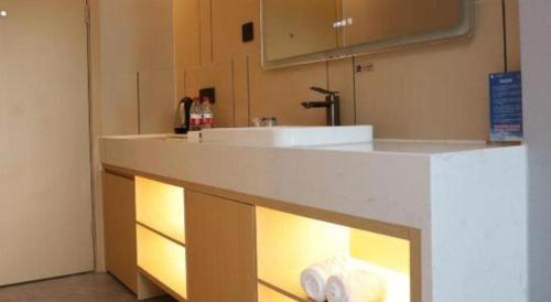 a kitchen with a counter with two rolls of toilet paper at Excemon Beach Hotel Beihai in Beihai