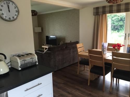 a living room with a couch and a table at Bruce's Cottage in Stirling